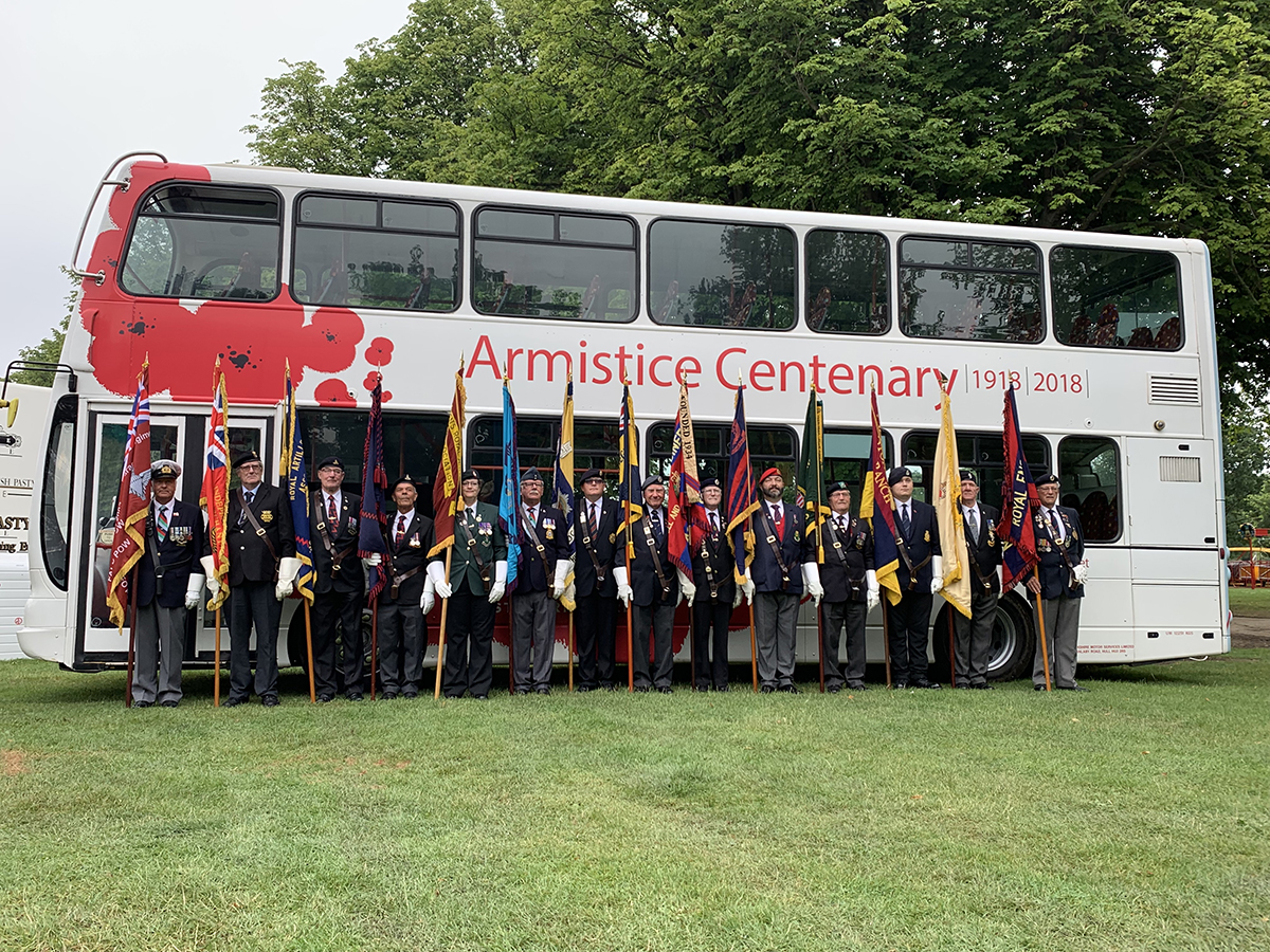 Veterans Weekend poppy bus veterans with flags July 2019