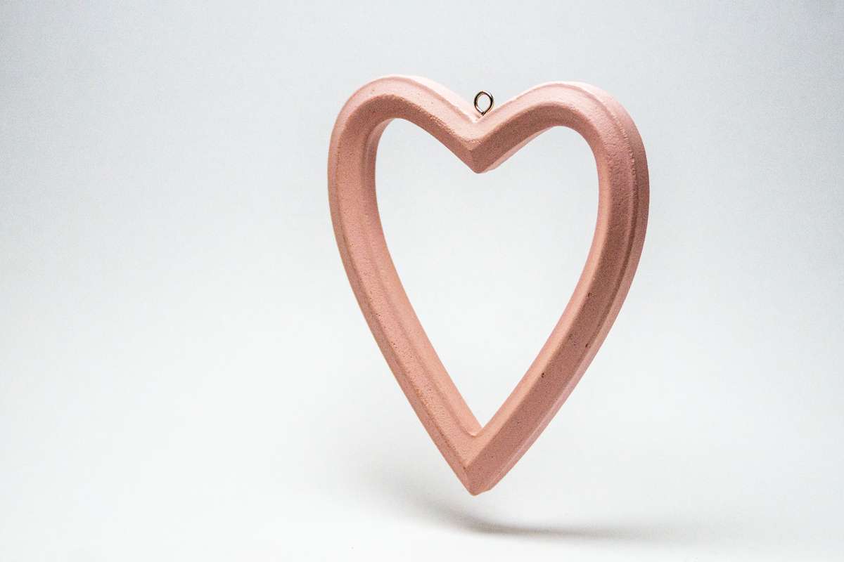 A rose-coloured heart seems to float just above the surface, levitating.